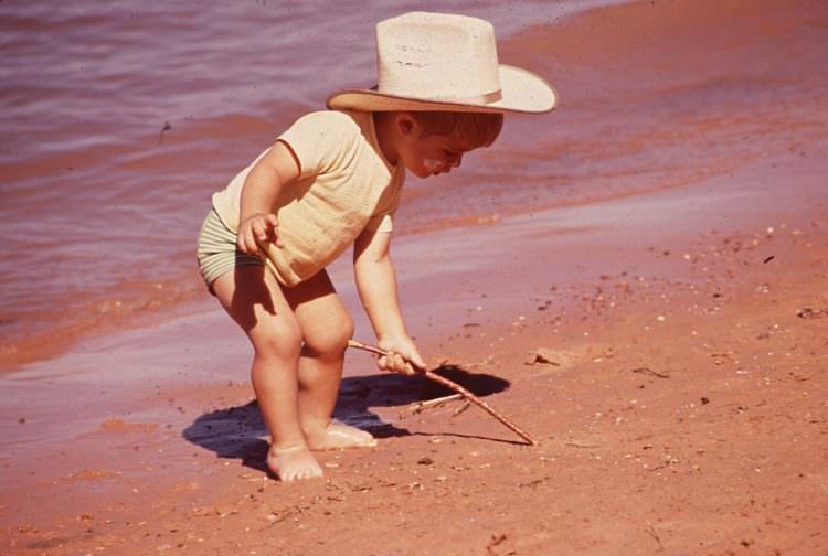 pick up toy while standing walking developmental milestone