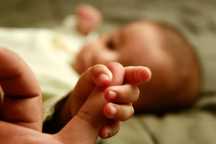 baby grabbing and releasing developmental milestones